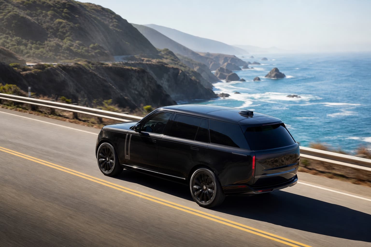 Luxury SUV driving the Pacific Coast Highway with ocean cliffs visible