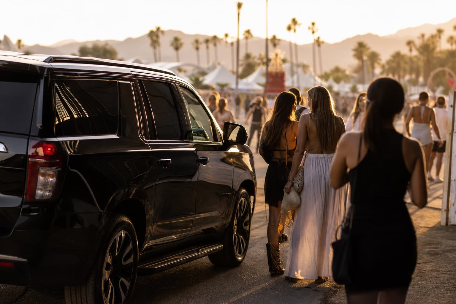 Luxury SUV arriving at a festival drop-off zone at golden hour